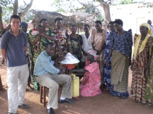 Benjamin Hans speaks with village leaders to a community about chlorine dispensers in Iganga, Uganda.