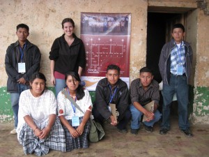 We helped organize a group of youth to interview and survey families in the community in order to gather information that would help us decide what types of development projects would be useful. We are standing in front of the future plans for the community center (internet center, library and salon for capacity building workshops).