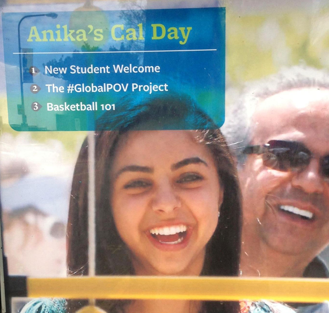 A bright and cheerful image of a young woman smiling widely. She is the focus of the photo, with a blurred background featuring another person, also smiling. The top part of the image has a transparent overlay with text that reads, "Anika's Cal Day." Below this, there are three items listed:

New Student Welcome
The #GlobalPOV Project
Basketball 101