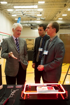 Matt Pavlovich and Connor Galleher sharing their project with President Clinton