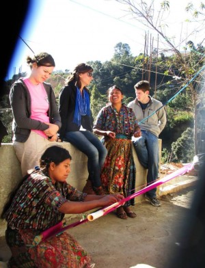 Alumna Nikki Brand’s GPP Practice Experience in Panajachel, Guatemala, inspired her to pursue a career in community development in Latin America. Here, Brand (seated, center) listens as her Guatemalan co-worker, Juana, tells students and interns her incredible life story while Juana’s sister Marcela demonstrates traditional backstrap weaving. Photo credit: Nikki Brand