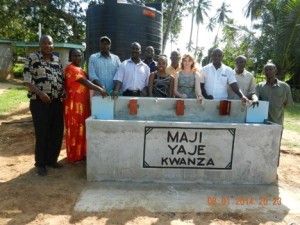 Celebrating accomplishment. Ashley Miller with Maji Yaje Kwanza community leaders at the new community water kiosk.