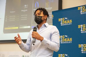 Blackbook University founder Ibrahim Baldé at the 2021 Big Ideas Grand Prize Pitch Day, talking into a microphone.