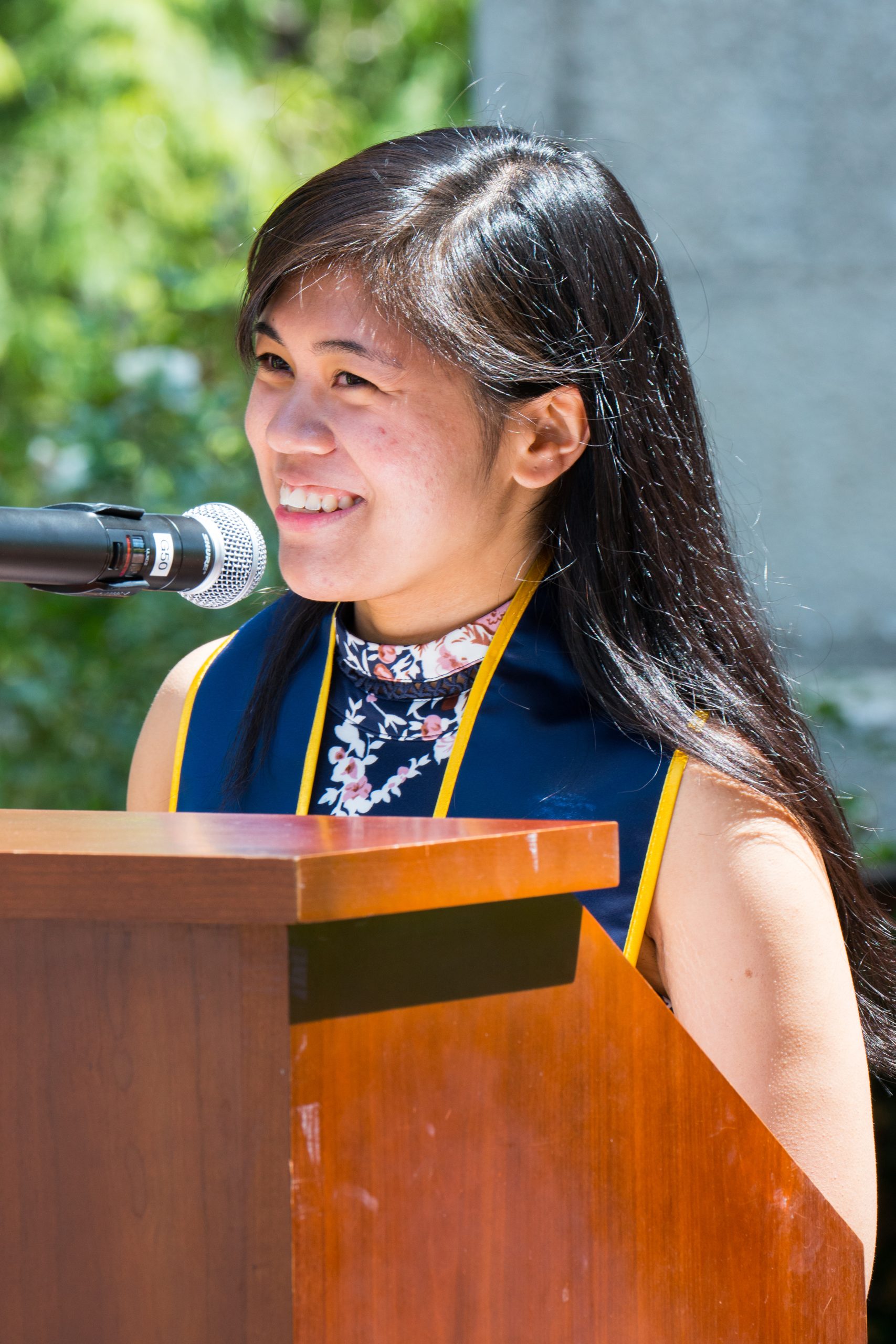Abigail Lomibao, a Cognitive Science major, delivers her spoken-word poem in front of her peers at the graduation ceremony.