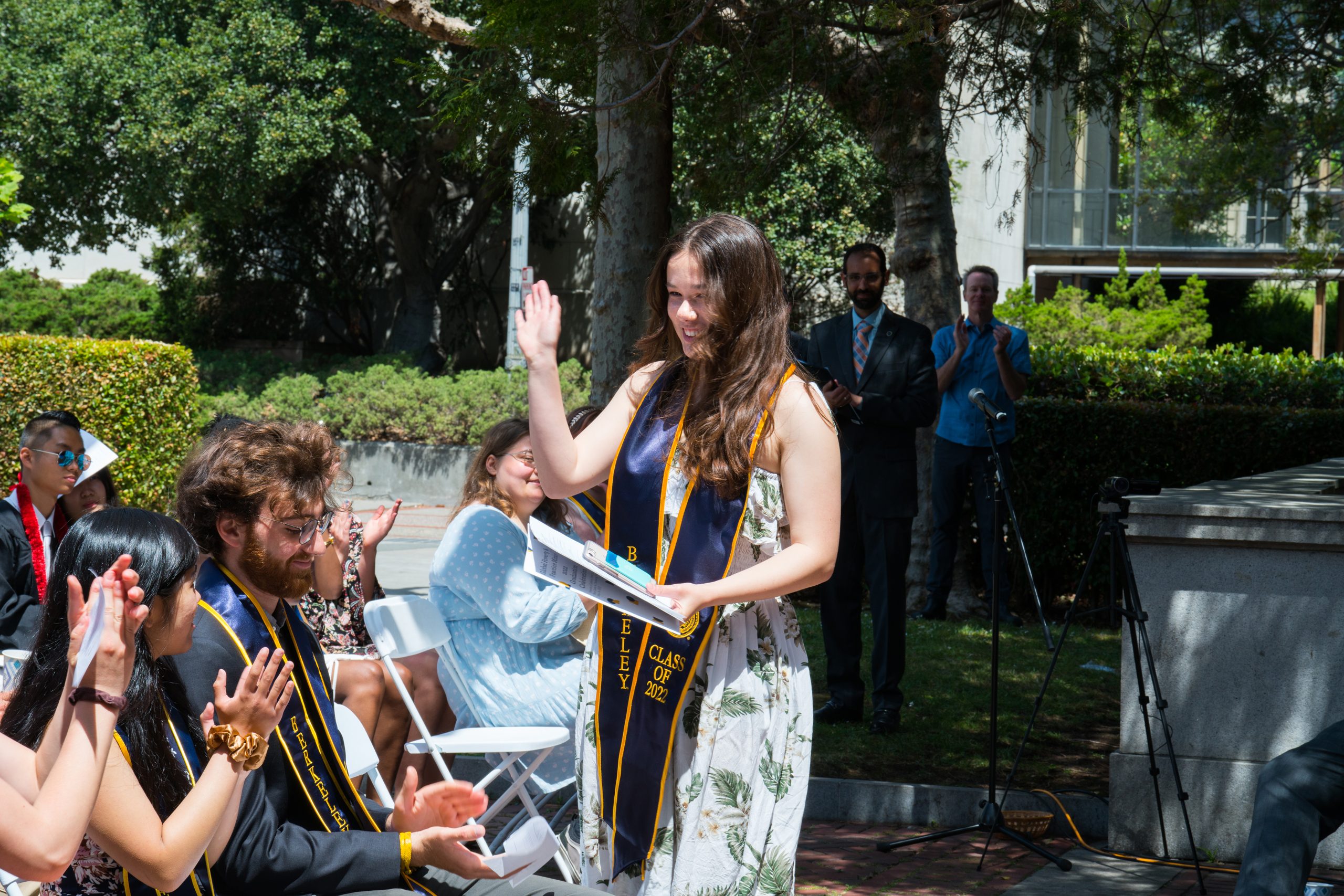 Madison Luzar, a Molecular Environmental Biology major, waves to the audience after delivering a powerful and emotional speech. 