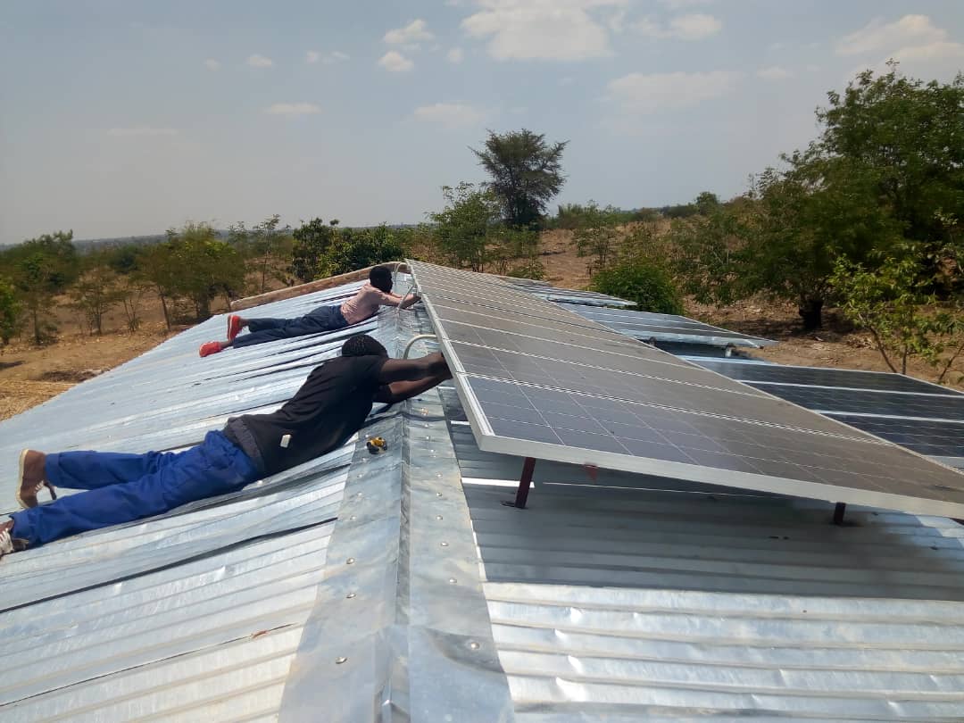 Solar panels being installed during Tisatayane's first attempt at sustainable development in Malawi. (Umodzi photo)