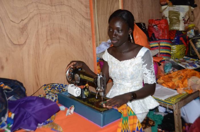 A SHE seamstress sews with her own machine at her own home. The social enterprise plans to hire many more seamstresses before officially launching in the spring. (Courtesy photo)