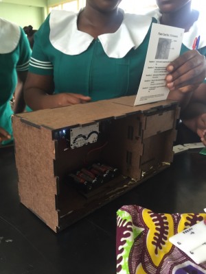 A group of Ghanaian women undergoing training with the use of a box that serves as a replica for the VIA training simulator.