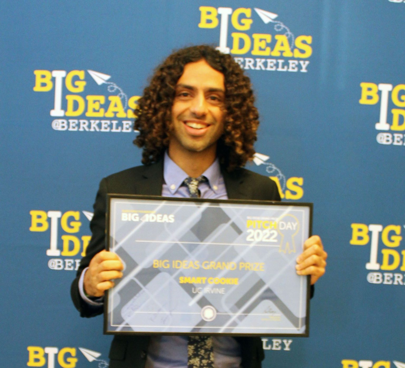 Daniel Haik showing the framed certificate for BIG IDEAS Grand Prize for Smart Cookie.