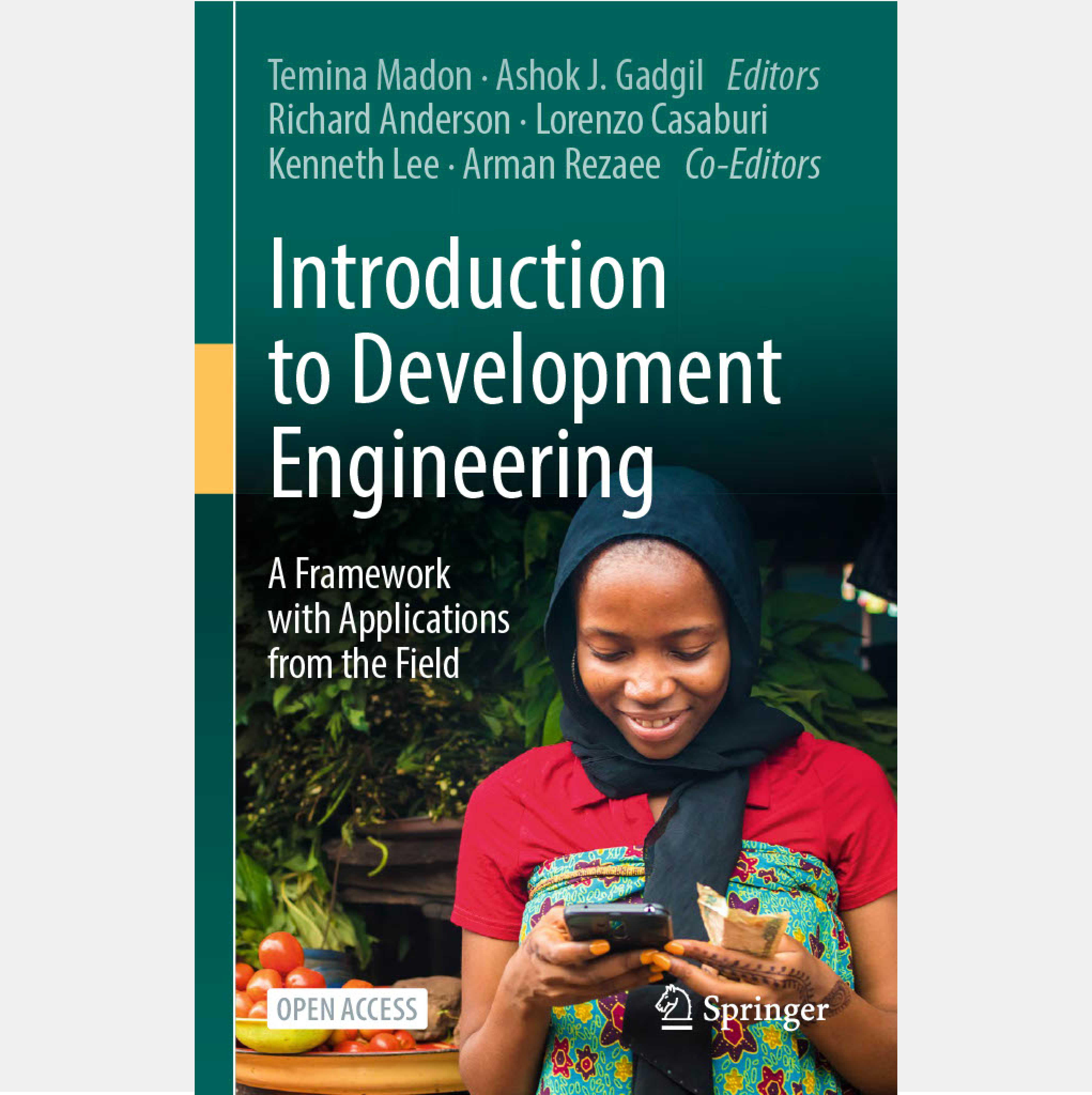 A book cover titled "Introduction to Development Engineering: A Framework with Applications from the Field." The cover features a young woman in colorful traditional attire, smiling as she looks at a mobile device, with fresh produce and greenery in the background.